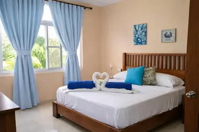 a bedroom with a bed with blue curtains at Sol Dominicus 1 Apartamento con Cocina Solo Adultos in La Laguna