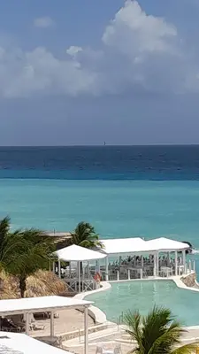 a swimming pool with the ocean in the background at Sol Dominicus 1 Apartamento con Cocina Solo Adultos in La Laguna