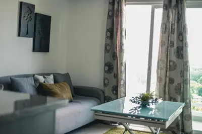 a living room with a couch and a glass table at ARMONIA 408 APARTMENT IN GAZCUE in Santo Domingo