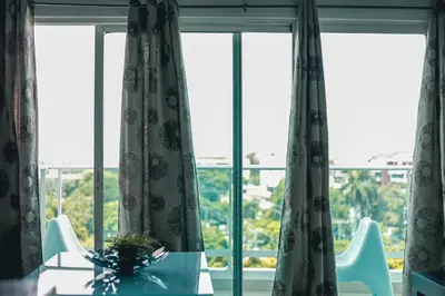 a table and chairs in front of a window at ARMONIA 408 APARTMENT IN GAZCUE in Santo Domingo