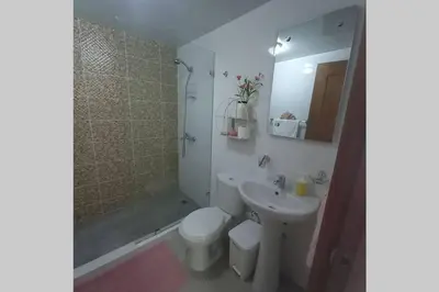 a bathroom with a sink and a toilet and a shower at Confortable apartamento de 3 tres habitaciones, con hermosa vista de area verde, ademas de piscinas y juegos infantiles en area recreativa in Santiago de los Caballeros