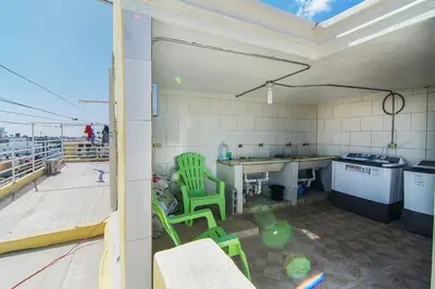a kitchen with green chairs and a table on a roof at 2 Bedroom-Apartment - Corales del Sur Ole Las Americas- Isabelita - Aeropuerto in La Viva