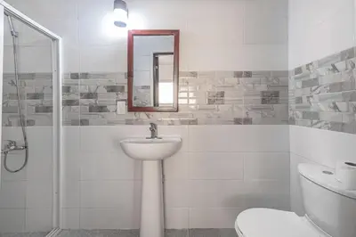 a bathroom with a sink and a toilet and a mirror at 2 Bedroom-Apartment - Corales del Sur Ole Las Americas- Isabelita - Aeropuerto in La Viva