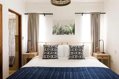 a bedroom with a blue and white bed with pillows at Punta Cana 2 Bedr. up to 6 guests 1 mile to Beach in Punta Cana