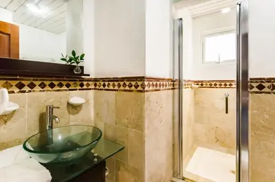 a bathroom with a glass sink and a shower at Punta Cana 2 Bedr. up to 6 guests 1 mile to Beach in Punta Cana