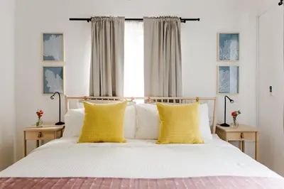 a bedroom with a bed with yellow pillows at Punta Cana 2 Bedr. up to 6 guests 1 mile to Beach in Punta Cana
