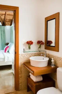 a bathroom with a sink and a mirror and a bed at Ocean View Villa/Luxury Puerto Bahia Resort/Samaná in Santa Bárbara de Samaná