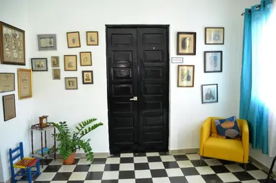 a black door in a room with a checkered floor at Hostal Mi Rincón in Santo Domingo