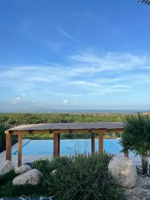 a picnic table with a view of a body of water at Altos de la Caobita in Barreras