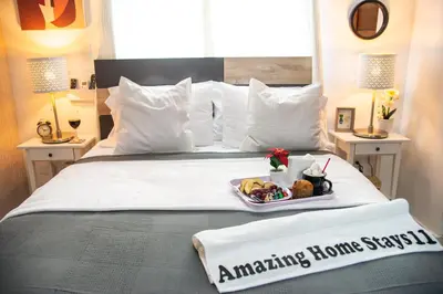 a hotel room with a bed with a tray of food on it at Self-checking-Fast internet-Alexa-Smart-Tv-AC-Hot Water in Ensanche Ozama