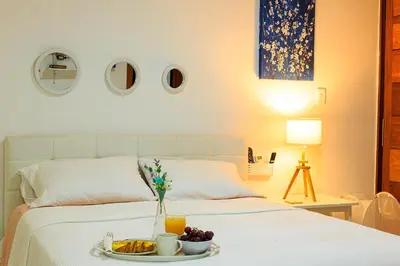 a bedroom with a bed with a tray of food on it at Self-checking-Fast internet-Alexa-Smart-Tv-AC-Hot Water in Ensanche Ozama