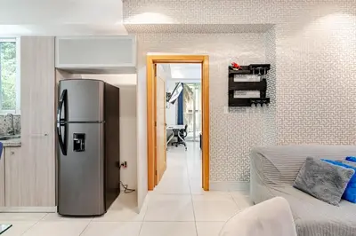 a kitchen with a stainless steel refrigerator in a room at Cozy Apartment near Downtown Center in Santo Domingo
