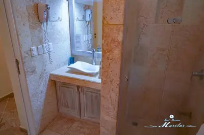 a bathroom with a shower and a sink and a mirror at Hotel Residence Marilar in Las Terrenas