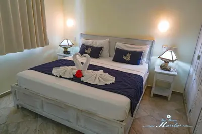a bedroom with a bed with two bows on it at Hotel Residence Marilar in Las Terrenas
