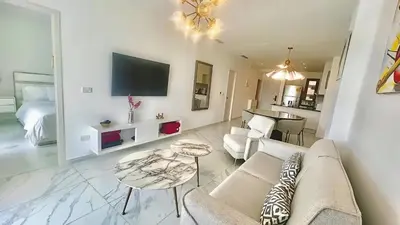 a living room with a couch and a table at Cana Rock Star Pool View Whith BBQ in Punta Cana