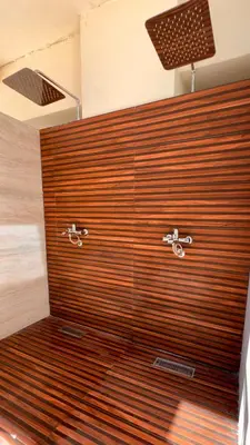 a bathroom with a shower with a wooden wall at Mar Mary Ocean View in Boca Chica