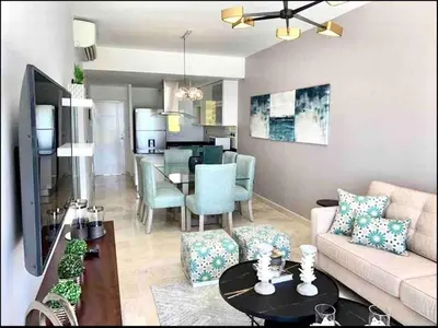 a living room with a couch and a table at Cana Rock Chic Golf de Lux in Punta Cana
