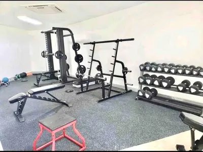 a fitness room with several machines and a table at Cana Rock Chic Golf de Lux in Punta Cana