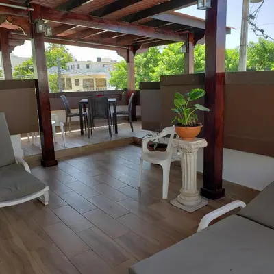 a patio with a table and chairs and a plant at Lovely location , right downtown Puerto Plata in San Felipe de Puerto Plata