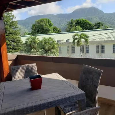 a table and chairs on a balcony with a view at Lovely location , right downtown Puerto Plata in San Felipe de Puerto Plata