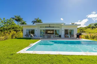 a house with a swimming pool in the yard at Villas Agua Dulce in Sosúa