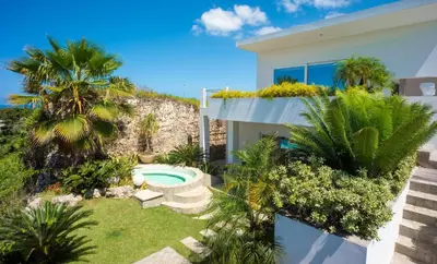 a house with a garden and a swimming pool at Villas Agua Dulce in Sosúa