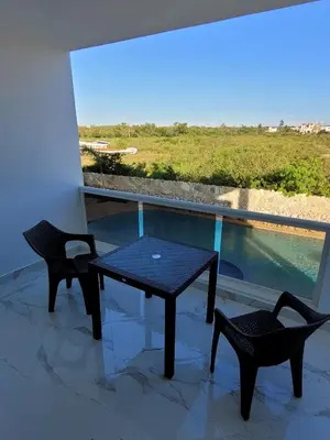 a table and two chairs on a balcony with a view at CASA MARAVILLOSA in Bayahibe