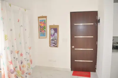 a room with a wooden door and a curtain at CASA MARAVILLOSA in Bayahibe