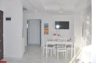 a white dining room with a white table and chairs at CASA MARAVILLOSA in Bayahibe