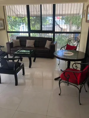 a living room with a couch and a table and chairs at Villa Luz in Baní