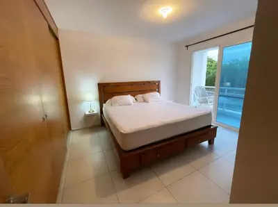 a bedroom with a bed and a large window at Casa en Paraiso RD in Bayahibe