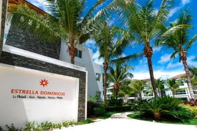 a sign in front of a building with palm trees at Casa en Paraiso RD in Bayahibe