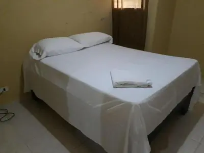 a white bed with white sheets and towels on it at Apartahotel Next Nivel - Queen Room in Punta Cana