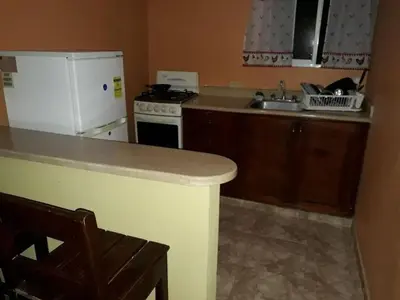 a kitchen with a white refrigerator and a sink at Apartahotel Next Nivel - Two bedroom Apartment in Punta Cana
