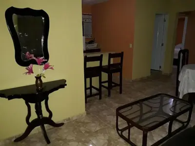 a room with a mirror and a table with flowers on it at Apartahotel Next Nivel - Two bedroom Apartment in Punta Cana