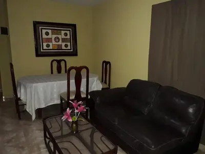 a living room with a couch and a table at Apartahotel Next Nivel - Two bedroom Apartment in Punta Cana