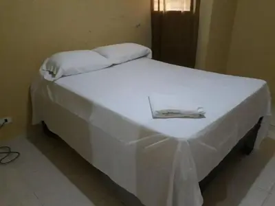 a white bed with white sheets and towels on it at Apartahotel Next Nivel - Two bedroom Apartment in Punta Cana