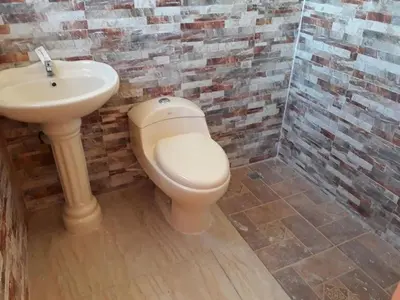 a bathroom with a toilet and a sink at Apartahotel Next Nivel - Two bedroom Apartment in Punta Cana