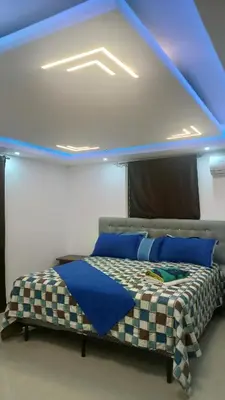 a bedroom with a bed with a blue ceiling at SANTIAGO PARADISE 111 S 3 in Santiago de los Caballeros