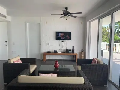 a living room with two couches and a ceiling fan at Spectacular Ocean View Spacious 2-Bedroom Condo, Vista Mare, Samana DR in Santa Bárbara de Samaná