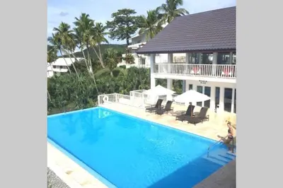 an image of a swimming pool in front of a house at Spectacular Ocean View Spacious 2-Bedroom Condo, Vista Mare, Samana DR in Santa Bárbara de Samaná