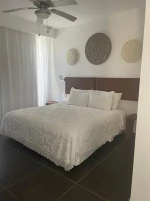 a bedroom with a bed with a ceiling fan at Spectacular Ocean View Spacious 2-Bedroom Condo, Vista Mare, Samana DR in Santa Bárbara de Samaná