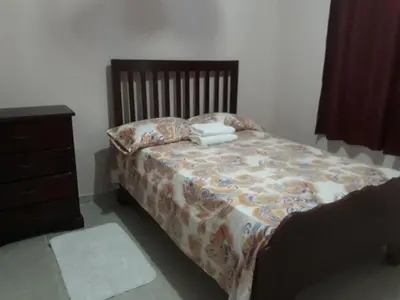 a bedroom with a bed and a dresser with towels on it at Apartahotel Next Nivel - Queen Room with Fan in Punta Cana