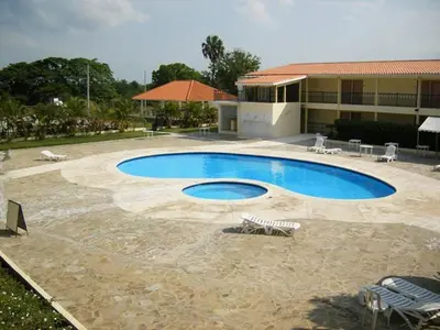 a large swimming pool in front of a building at Hotel Las Caobas in San Francisco de Macorís