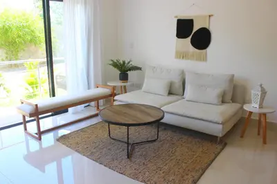 a living room with a couch and a table at Amar'e Aparthotel & Spa in Las Terrenas