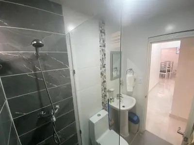 a bathroom with a shower and a toilet and a sink at 7DR Apt in Prime Location Near Monumental Area in Santiago de los Caballeros