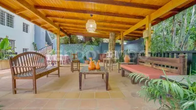 a patio with benches and a table and chairs at El Yaguacil Aparta Hotel in Jarabacoa