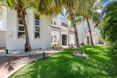 a house with palm trees in front of it at Best Private Cocotal Villas in Punta Cana in Punta Cana