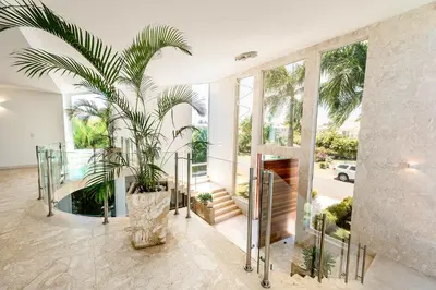 a house with a palm tree in a room with windows at Best Private Cocotal Villas in Punta Cana in Punta Cana