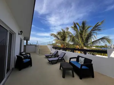 a balcony with chairs and a view of the ocean at Apartamento Carey in Cabrera
